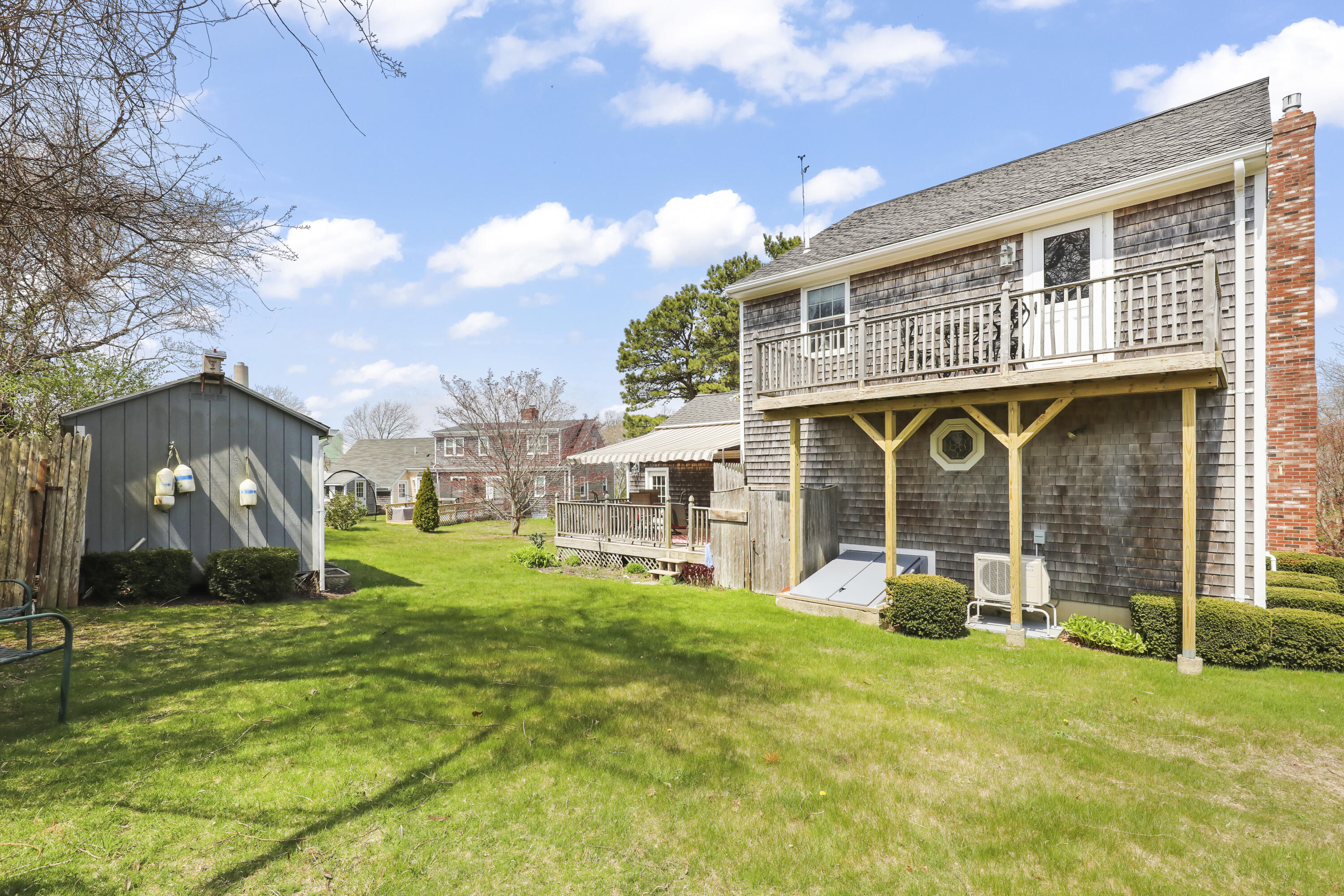 36 Town Neck Road Sandwich, MA 02563 - Photo 11 of 67 a front view of a house with a yard table and chairs
