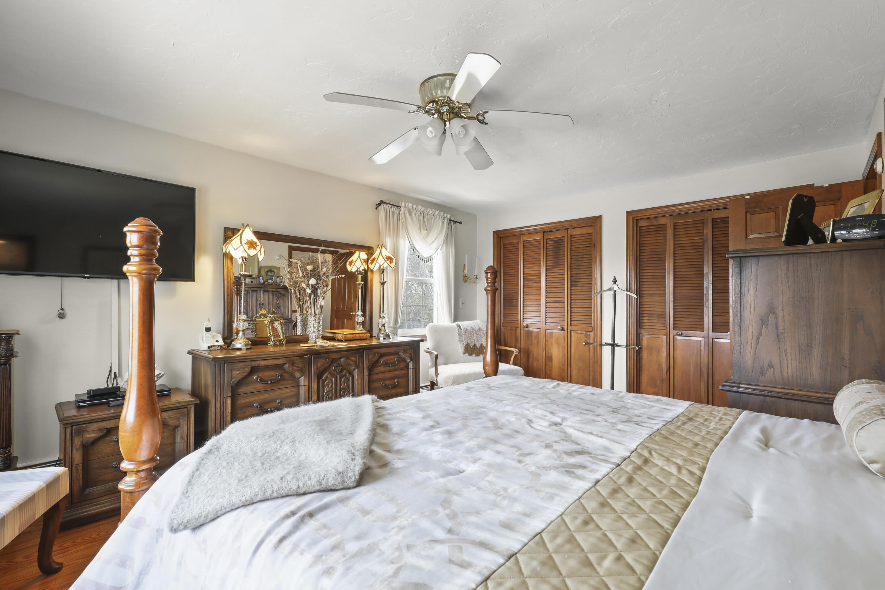 36 Town Neck Road Sandwich, MA 02563 - Photo 37 of 67 a bedroom with a bed and a chandelier