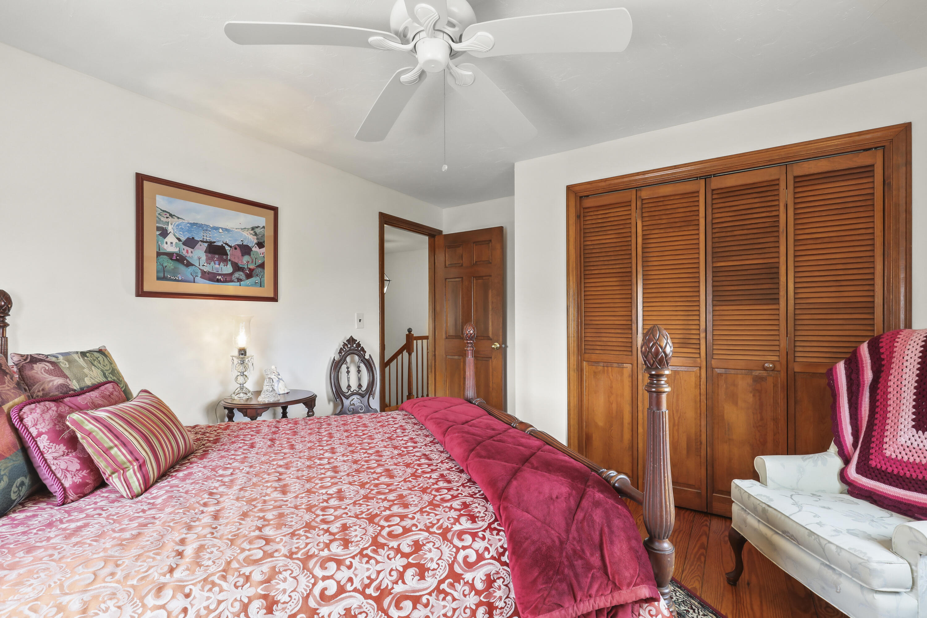 36 Town Neck Road Sandwich, MA 02563 - Photo 43 of 67 a bedroom with a large bed and a chandelier