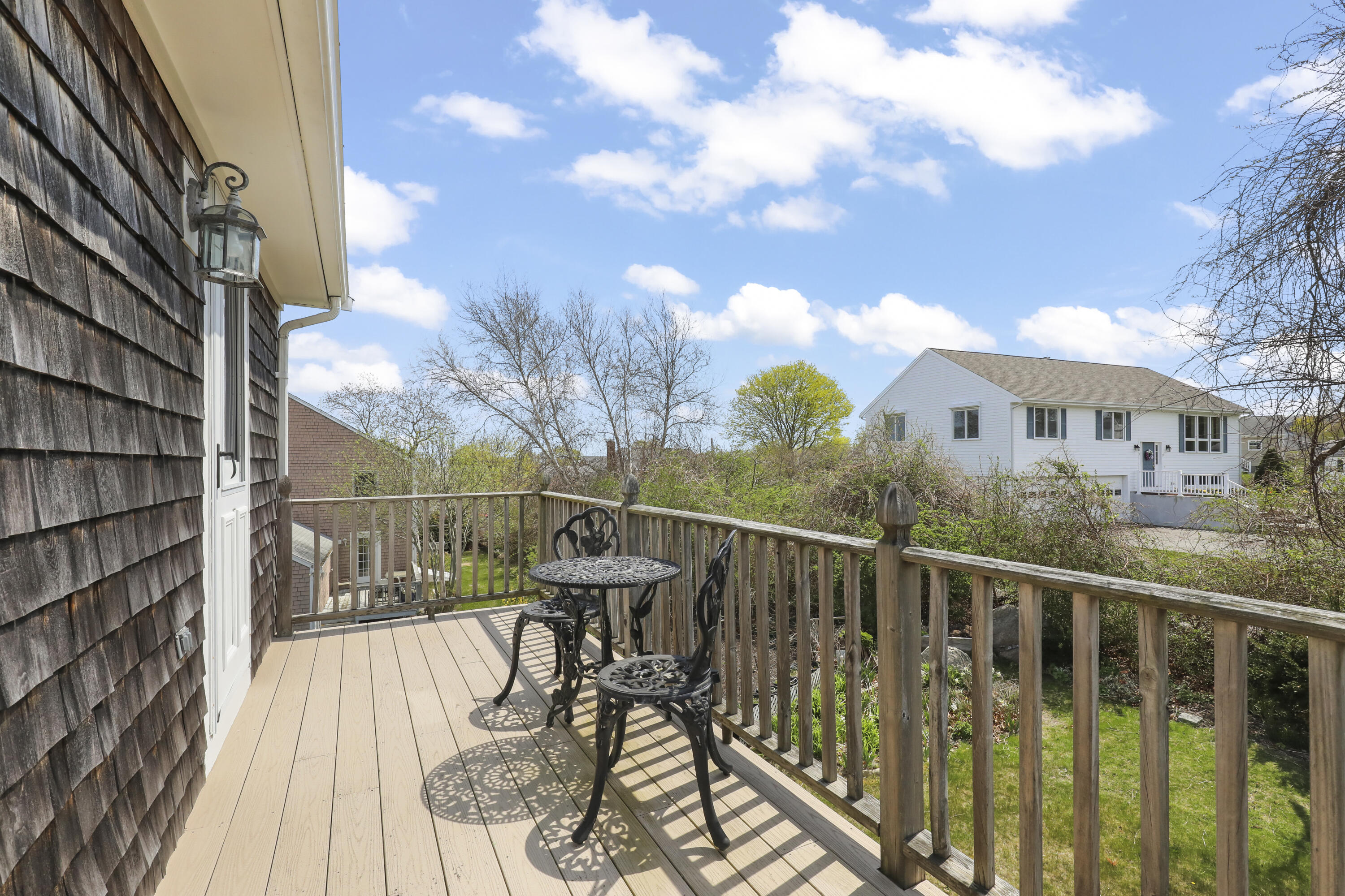 36 Town Neck Road Sandwich, MA 02563 - Photo 48 of 67 a view of a balcony with two chairs and wooden fence