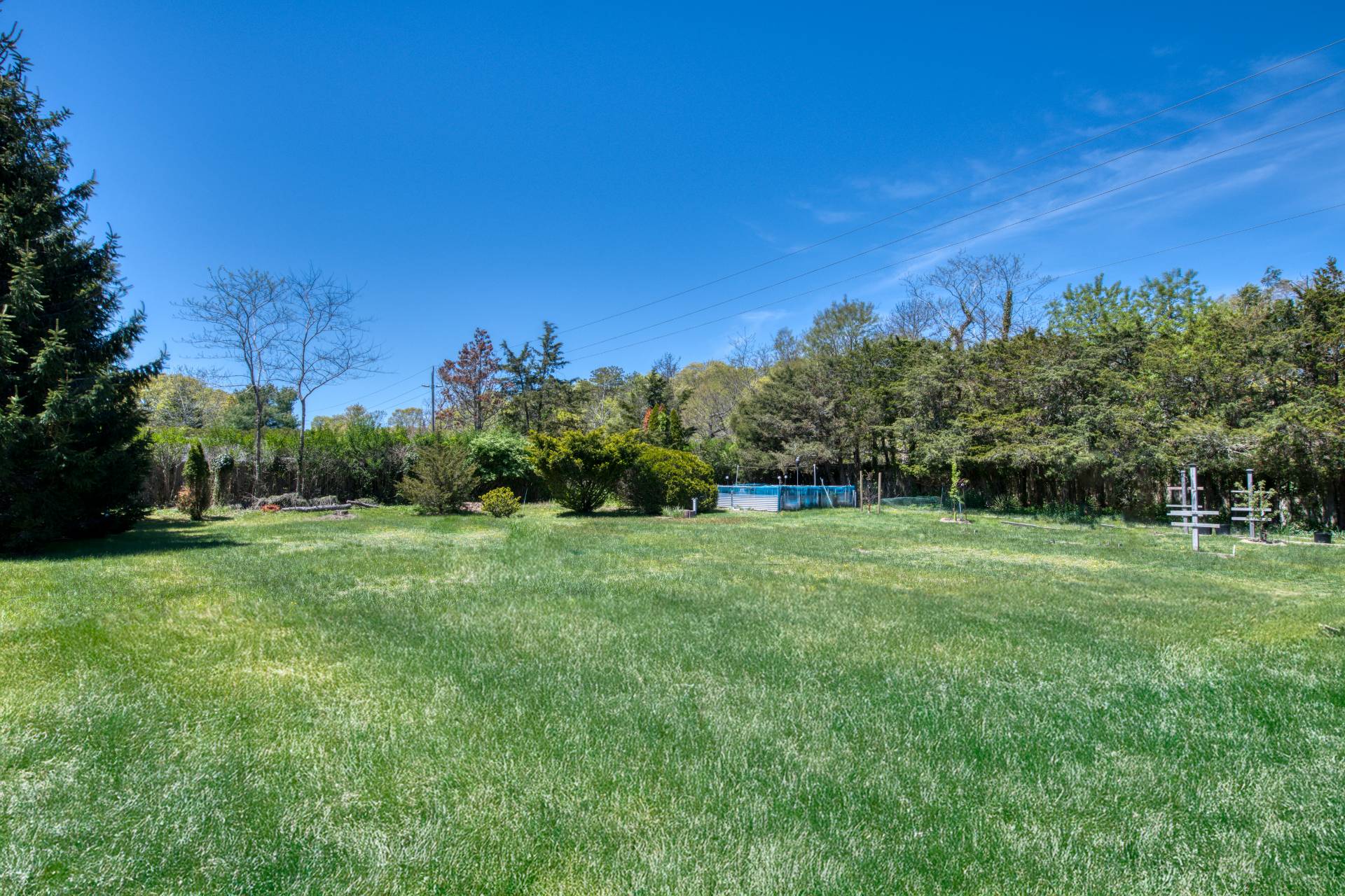 88 Old Country Road East Quogue, NY 11942 - Photo 9 of 10 a view of a field with trees in the background