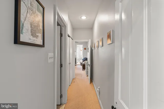 a view of a hallway with paintings on the wall