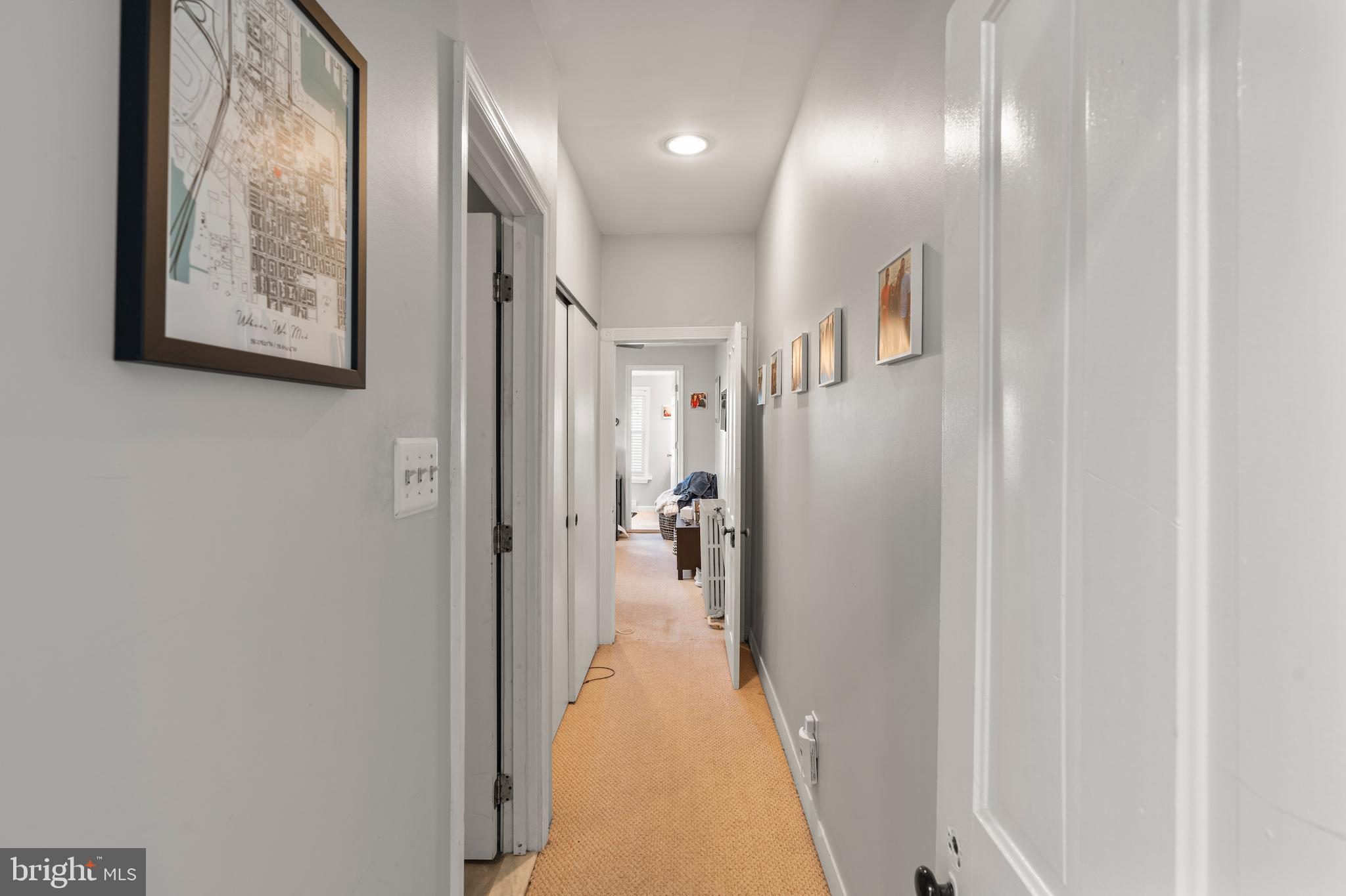 1043 Riverside Avenue Baltimore, MD 21230 - Photo 13 of 41 a view of a hallway with paintings on the wall