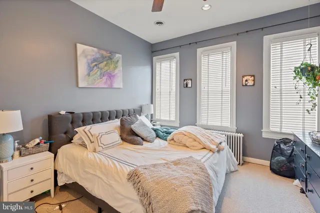 a bedroom with bed and a window