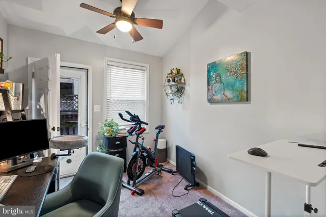 a view of a workspace with furniture and a window