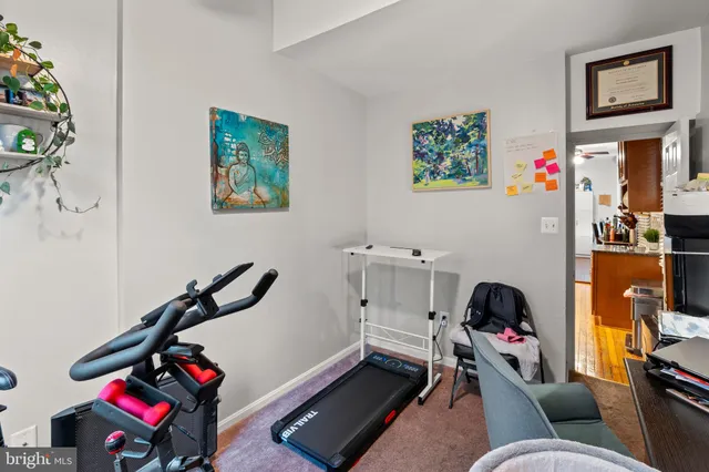 a room with furniture a rug and a fan