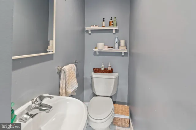 a white toilet sitting next to a bathroom sink