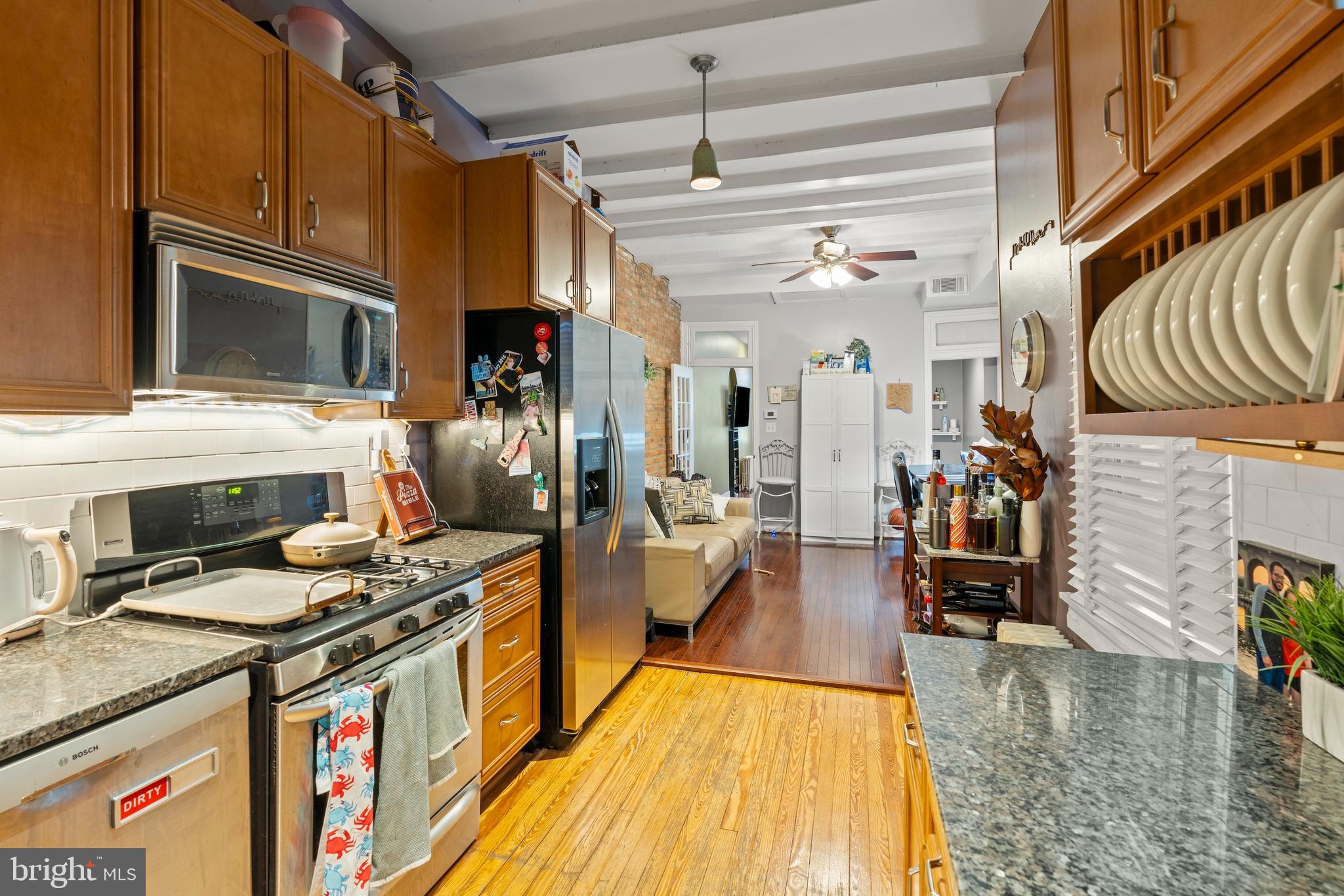 1043 Riverside Avenue Baltimore, MD 21230 - Photo 3 of 41 a kitchen with stainless steel appliances granite countertop a stove and cabinets
