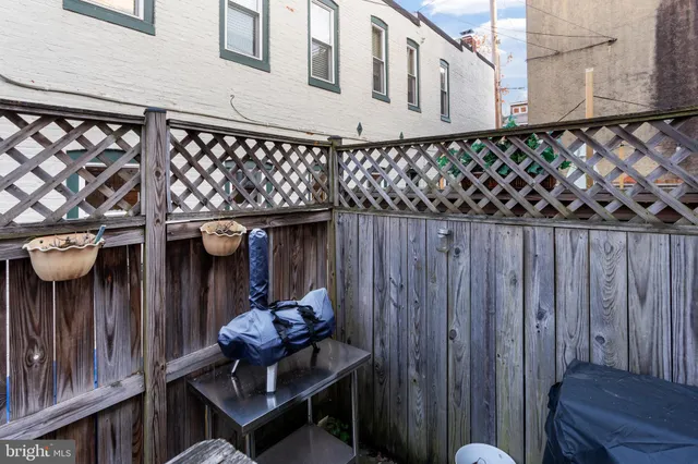 a side of house with wooden fence