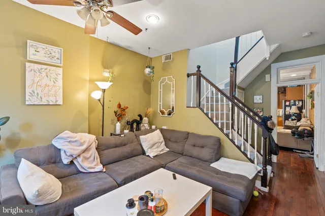 a living room with furniture and wooden floor