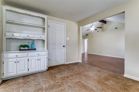 a kitchen with granite countertop a stove a sink a refrigerator and cabinets