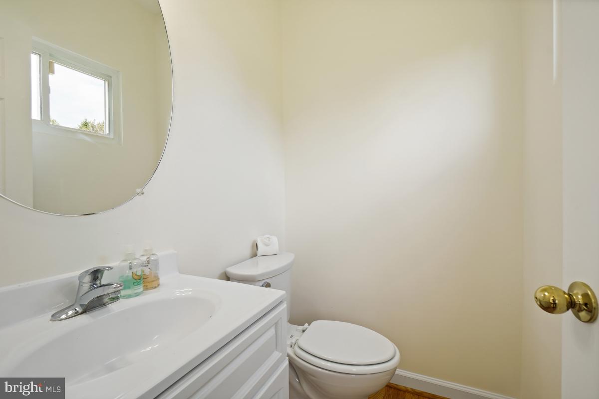 18521 Cornflower Road Boyds, MD 20841 - Photo 19 of 62 a bathroom with a sink a toilet and mirror