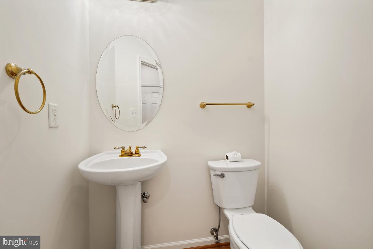 18521 Cornflower Road Boyds, MD 20841 - Photo 20 of 62 a bathroom with a toilet sink and mirror