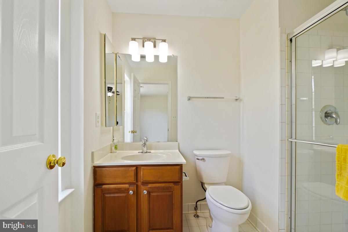 18521 Cornflower Road Boyds, MD 20841 - Photo 25 of 62 a bathroom with a granite countertop sink toilet and shower