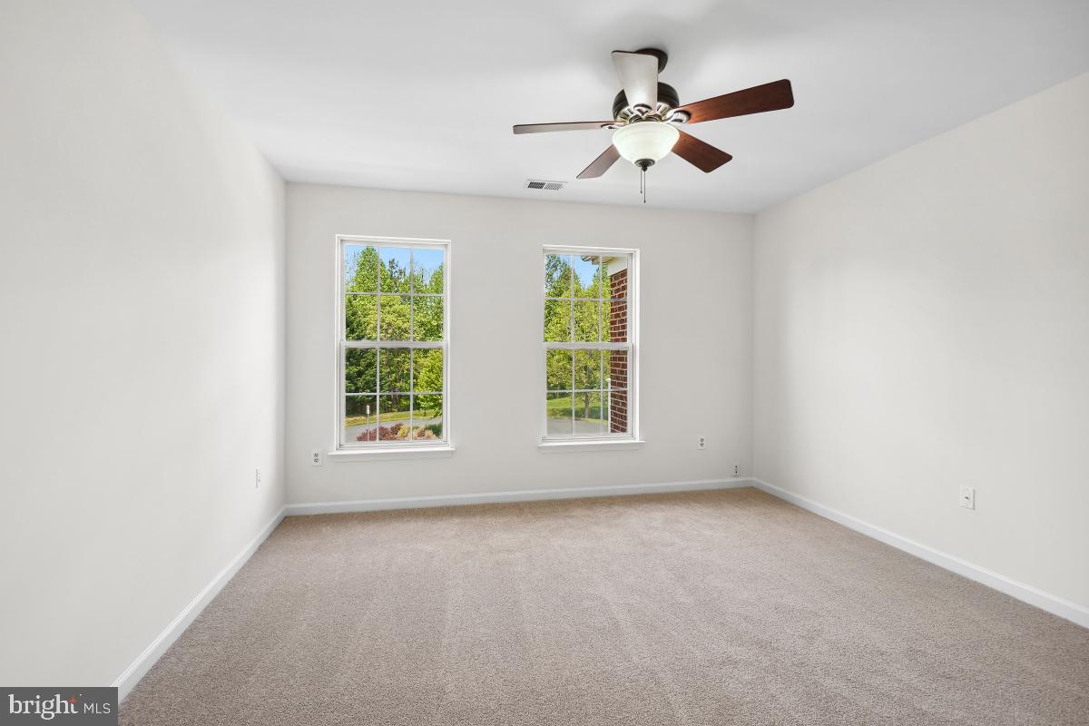 18521 Cornflower Road Boyds, MD 20841 - Photo 27 of 62 an empty room with ceiling fan and windows