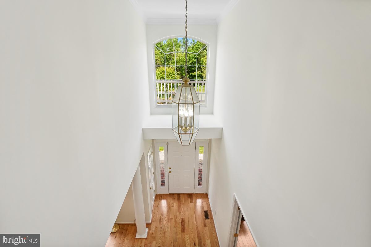 18521 Cornflower Road Boyds, MD 20841 - Photo 31 of 62 a view of a hallway with wooden floor and staircase
