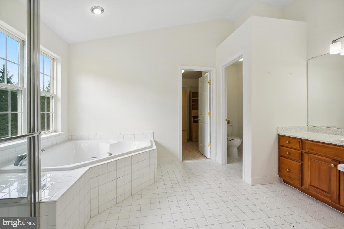 18521 Cornflower Road Boyds, MD 20841 - Photo 34 of 62 a spacious bathroom with a bathtub and a sink