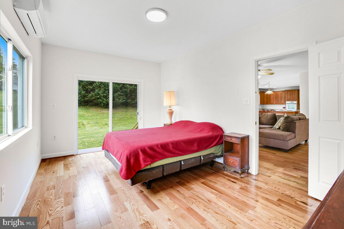 18521 Cornflower Road Boyds, MD 20841 - Photo 52 of 62 a spacious bedroom with a bed and wooden floor