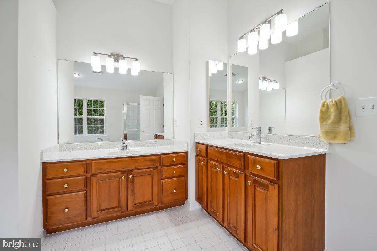 18521 Cornflower Road Boyds, MD 20841 - Photo 58 of 62 a bathroom with a sink double vanity and a mirror