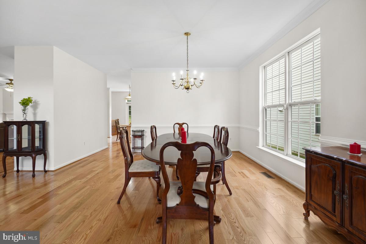 18521 Cornflower Road Boyds, MD 20841 - Photo 6 of 62 a dining room with furniture a chandelier and wooden floor