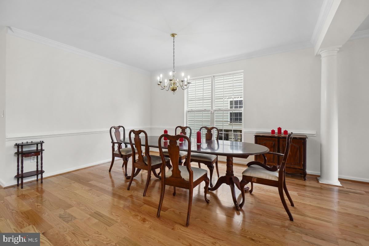 18521 Cornflower Road Boyds, MD 20841 - Photo 7 of 62 a dining room with furniture a chandelier and wooden floor
