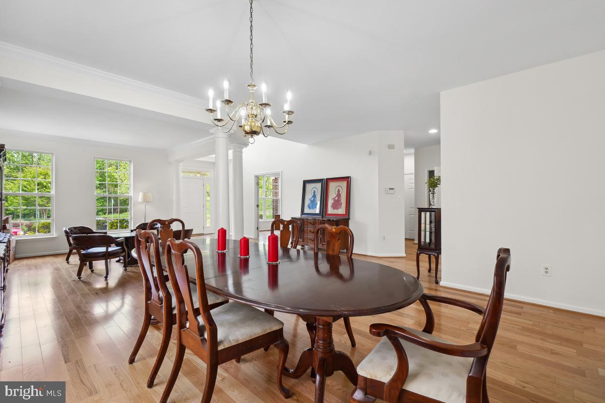 18521 Cornflower Road Boyds, MD 20841 - Photo 8 of 62 a view of a dining room with furniture and wooden floor