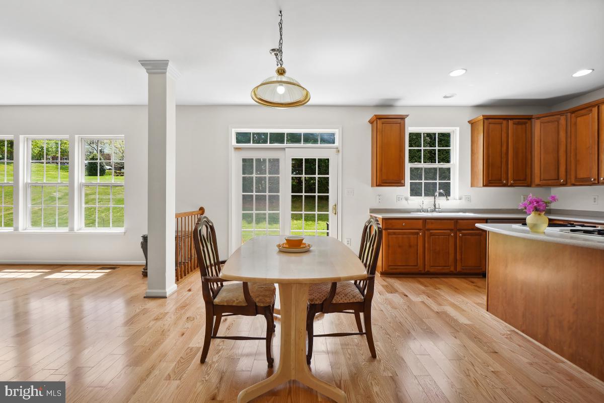 18521 Cornflower Road Boyds, MD 20841 - Photo 9 of 62 a dining room with wooden floor and large window