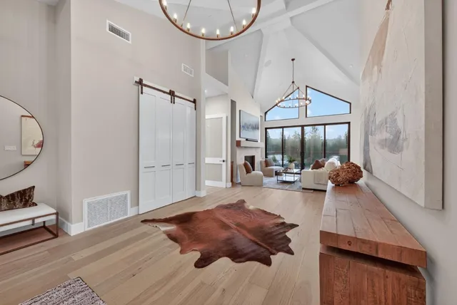 a view of chairs and table in patio with wooden floor
