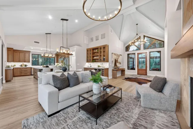 a kitchen with a refrigerator a sink and chairs