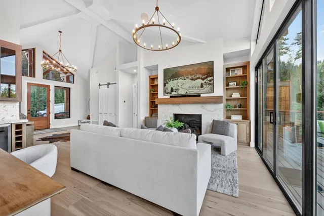 a kitchen with stainless steel appliances granite countertop a stove a sink a refrigerator dining table and chairs