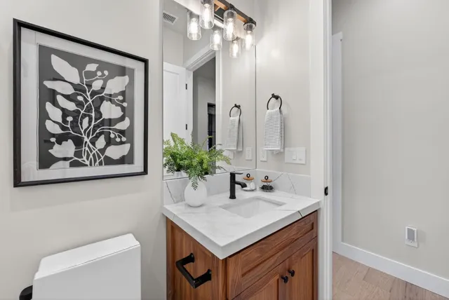 a bed room with a bed mirror and a table