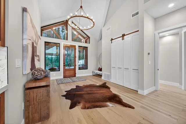 a living room with furniture fireplace and floor to ceiling windows