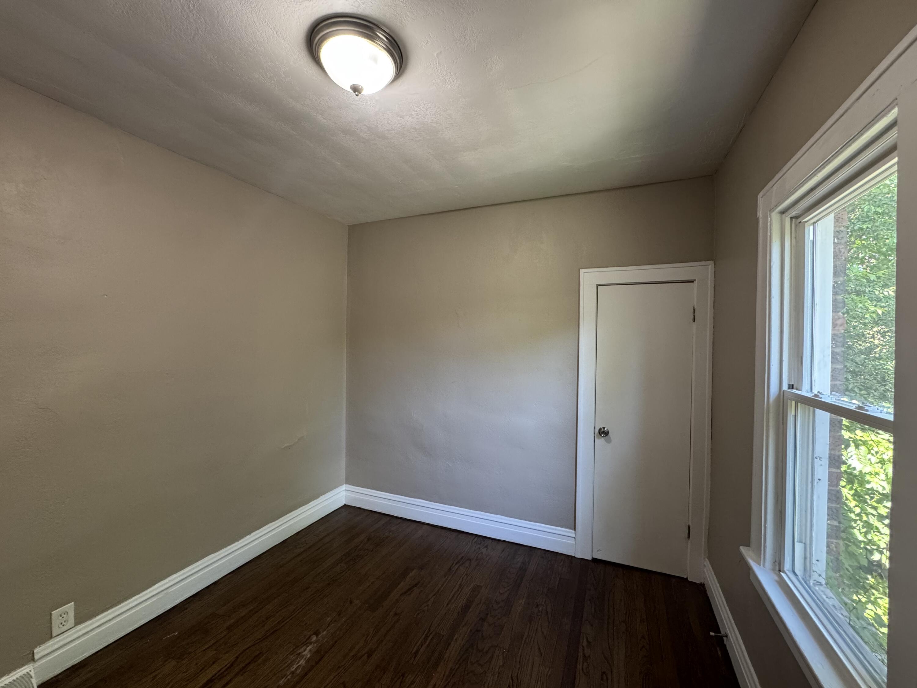 3844 Adams Street Gary, IN 46408 - Photo 11 of 17 an empty room with wooden floor and windows
