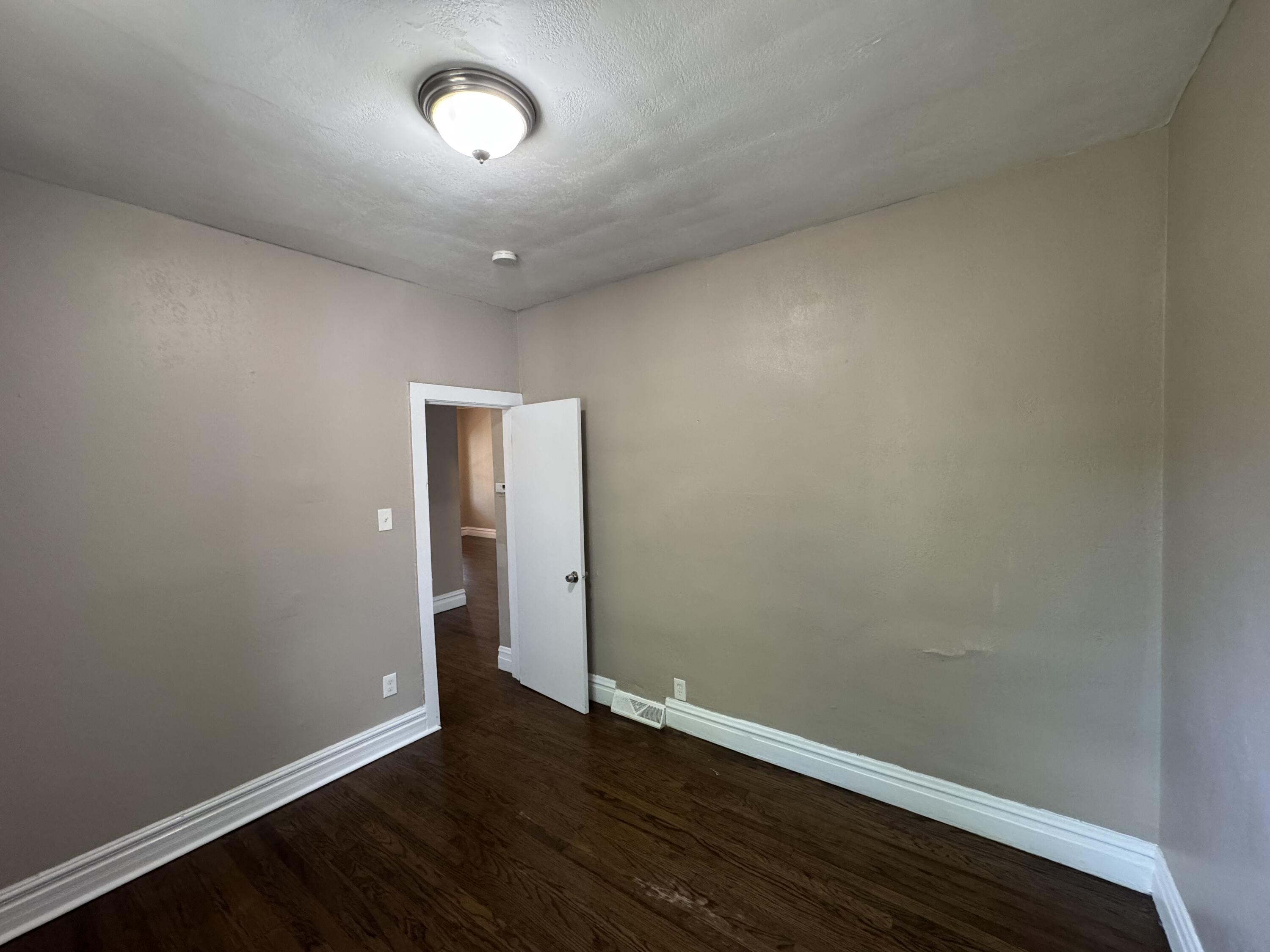 3844 Adams Street Gary, IN 46408 - Photo 12 of 17 an empty room with wooden floor and windows