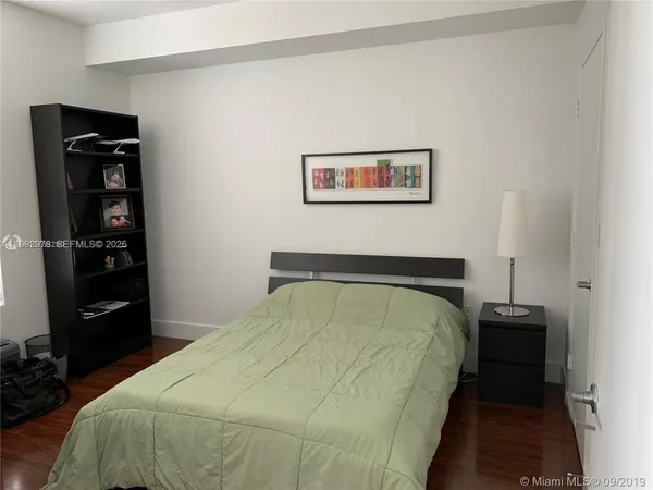 a bedroom with a bed and a closet