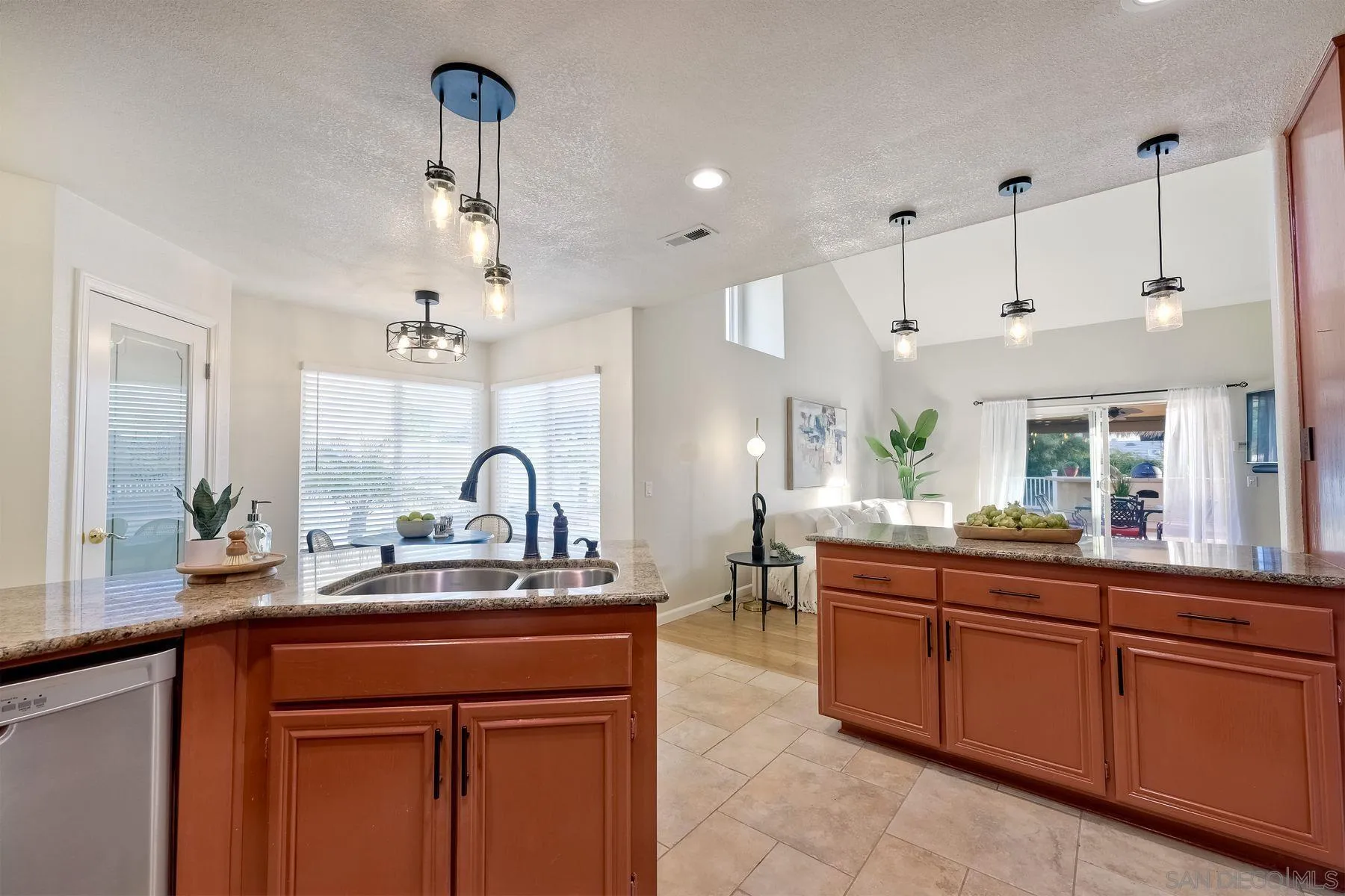 2859 Manzanita View Road Alpine, CA 91901 - Photo 27 of 66 a kitchen with kitchen island granite countertop a sink and a refrigerator