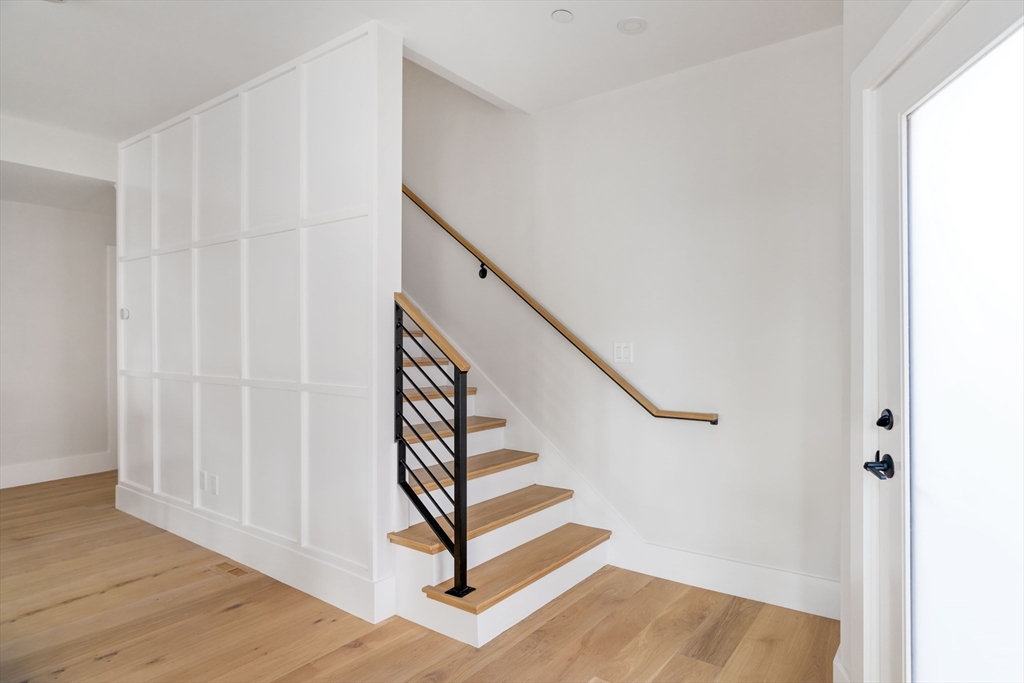 8 Poplar Road, Unit A Cambridge, MA 02138 - Photo 11 of 35 a view of entryway with wooden floor and stairs