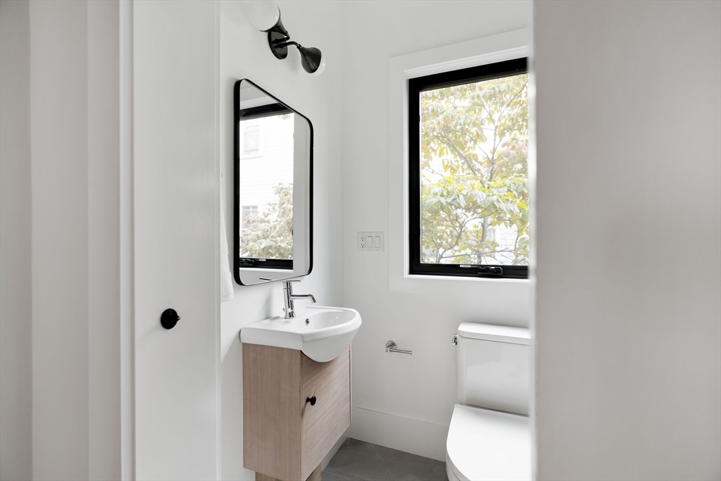 8 Poplar Road, Unit A Cambridge, MA 02138 - Photo 13 of 35 a bathroom with a toilet a sink and a mirror