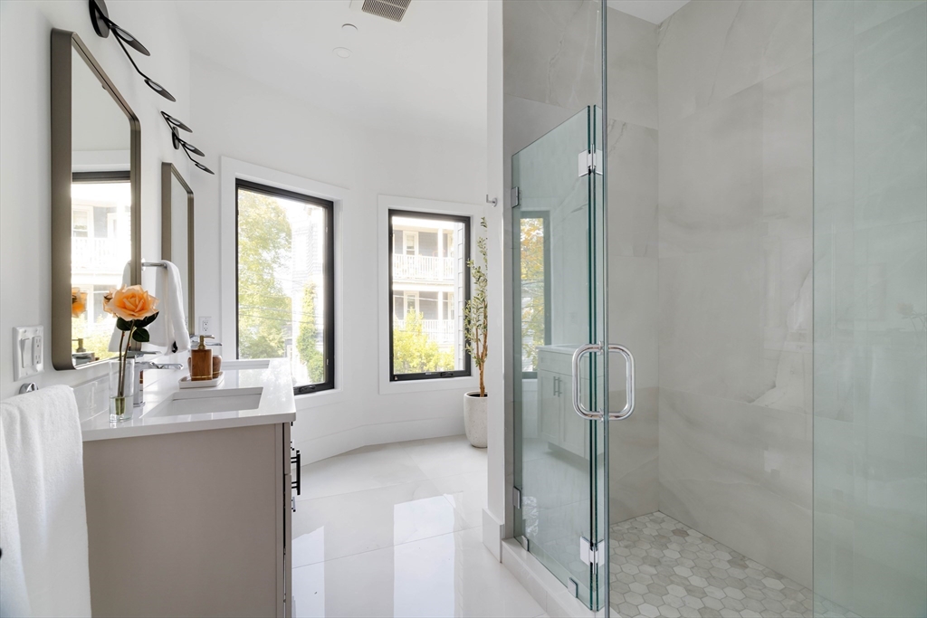 8 Poplar Road, Unit A Cambridge, MA 02138 - Photo 20 of 35 a spacious bathroom with sink and mirror with shower