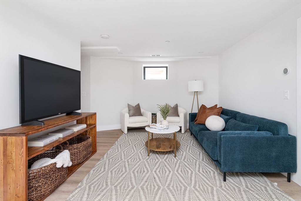 8 Poplar Road, Unit A Cambridge, MA 02138 - Photo 25 of 35 a living room with furniture and a flat screen tv