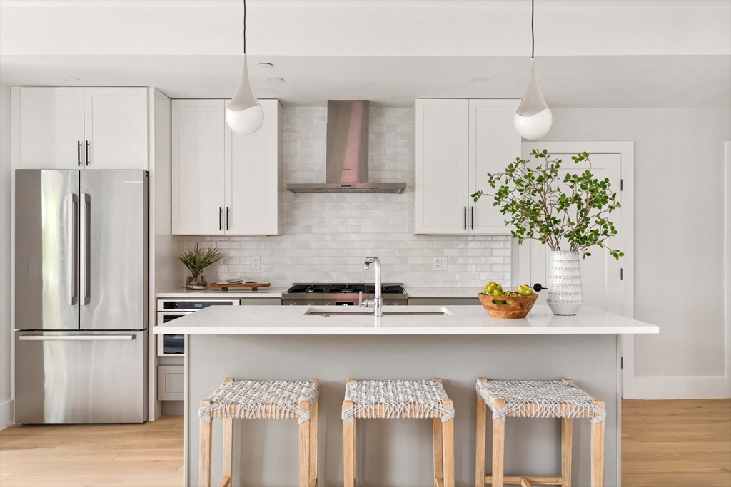 8 Poplar Road, Unit A Cambridge, MA 02138 - Photo 3 of 35 a kitchen with stainless steel appliances granite countertop a sink a stove and a refrigerator