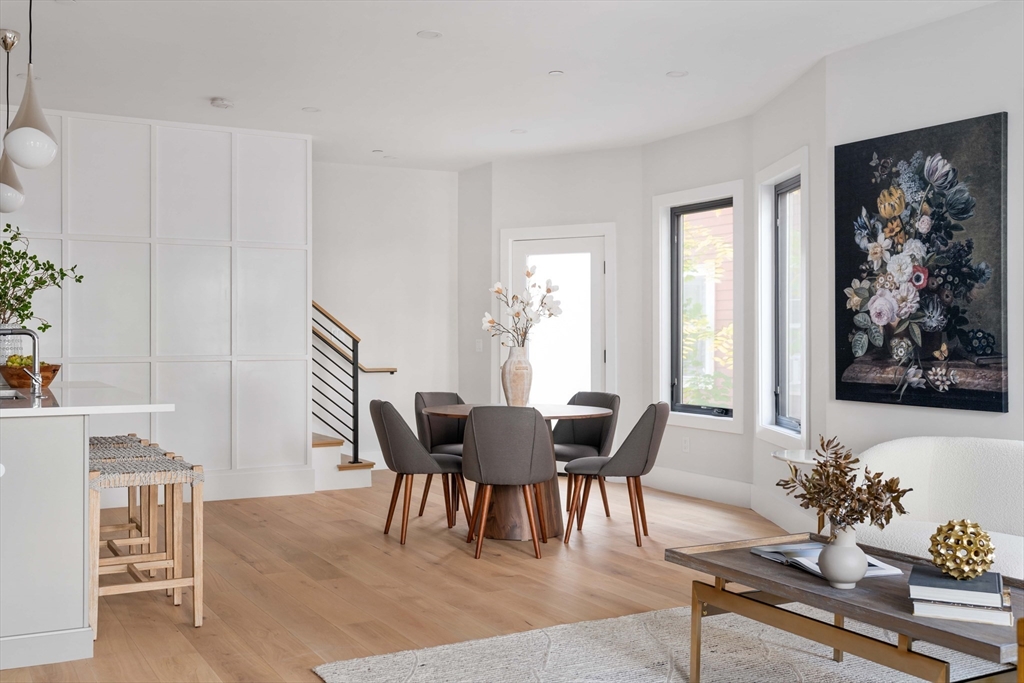 8 Poplar Road, Unit A Cambridge, MA 02138 - Photo 5 of 35 a dining room with furniture potted plants and wooden floor