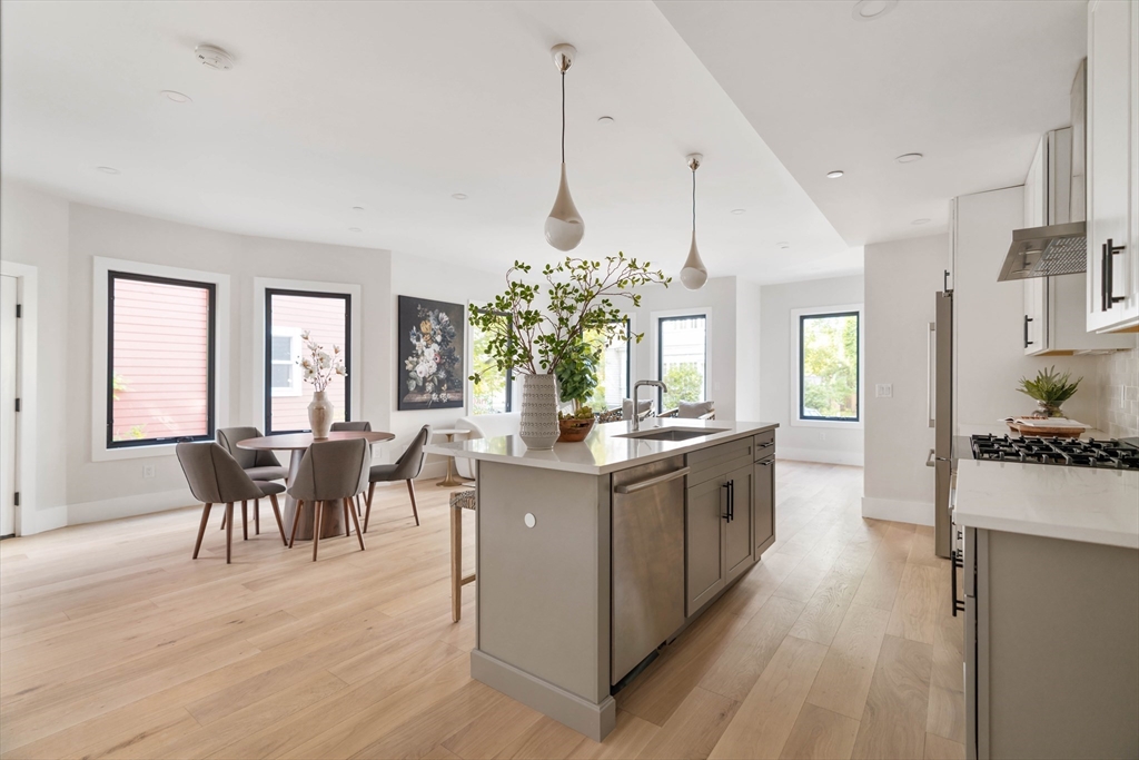 8 Poplar Road, Unit A Cambridge, MA 02138 - Photo 10 of 35 a kitchen with stainless steel appliances granite countertop a stove and cabinets