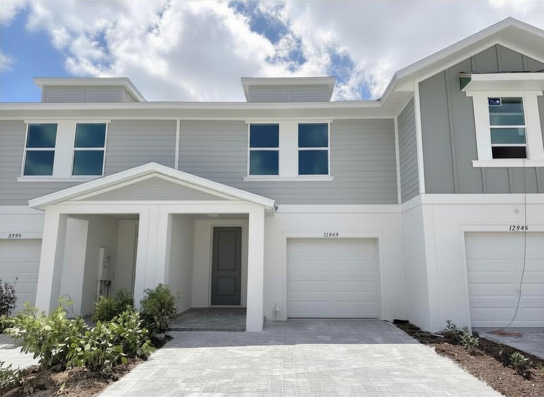 12949 Southwest Forli Way Port St. Lucie, FL 34987 - Photo 1 of 13 a front view of a house with a yard