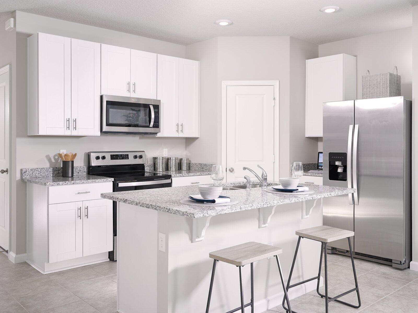 12949 Southwest Forli Way Port St. Lucie, FL 34987 - Photo 3 of 13 a kitchen with stainless steel appliances granite countertop a refrigerator a stove a sink a dining table and chairs