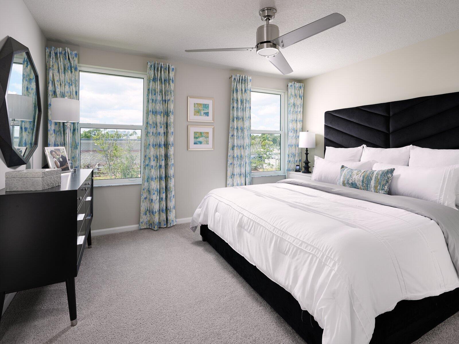 12949 Southwest Forli Way Port St. Lucie, FL 34987 - Photo 7 of 13 a bedroom with a bed a mirror and a large window