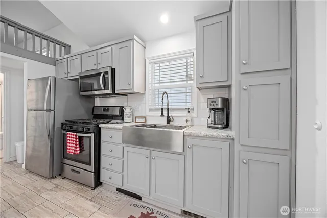 a kitchen with stainless steel appliances granite countertop a refrigerator stove and sink