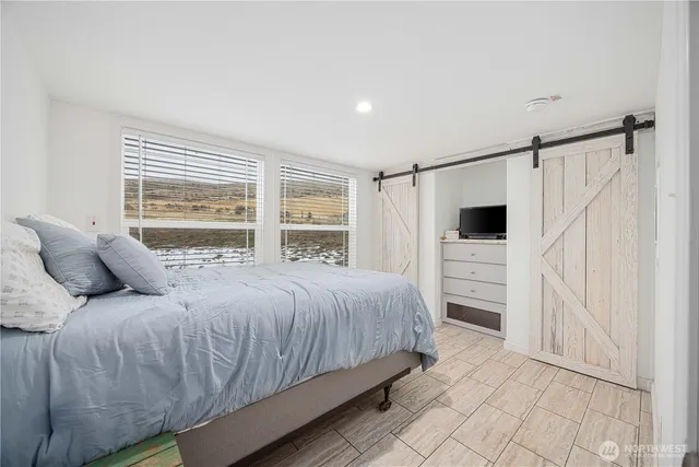 a bedroom with a bed and window