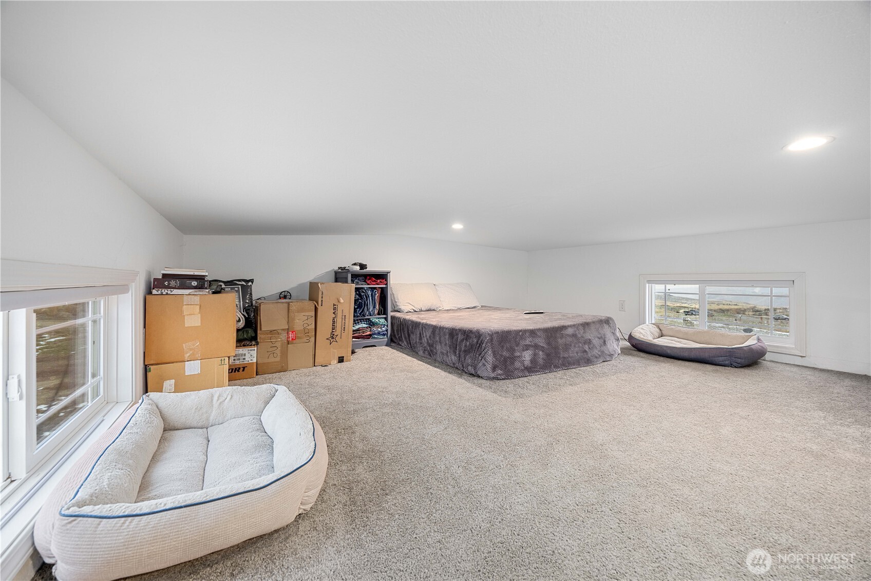 577 Bill Shaw Road Pateros, WA 98846 - Photo 17 of 40 a spacious bedroom with a bed and window