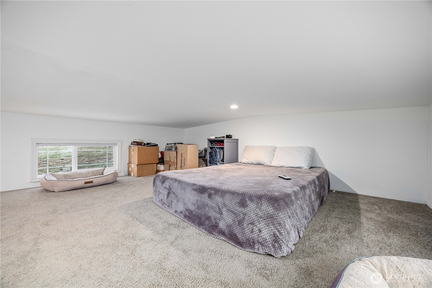 577 Bill Shaw Road Pateros, WA 98846 - Photo 18 of 40 a spacious bedroom with a bed and a large window